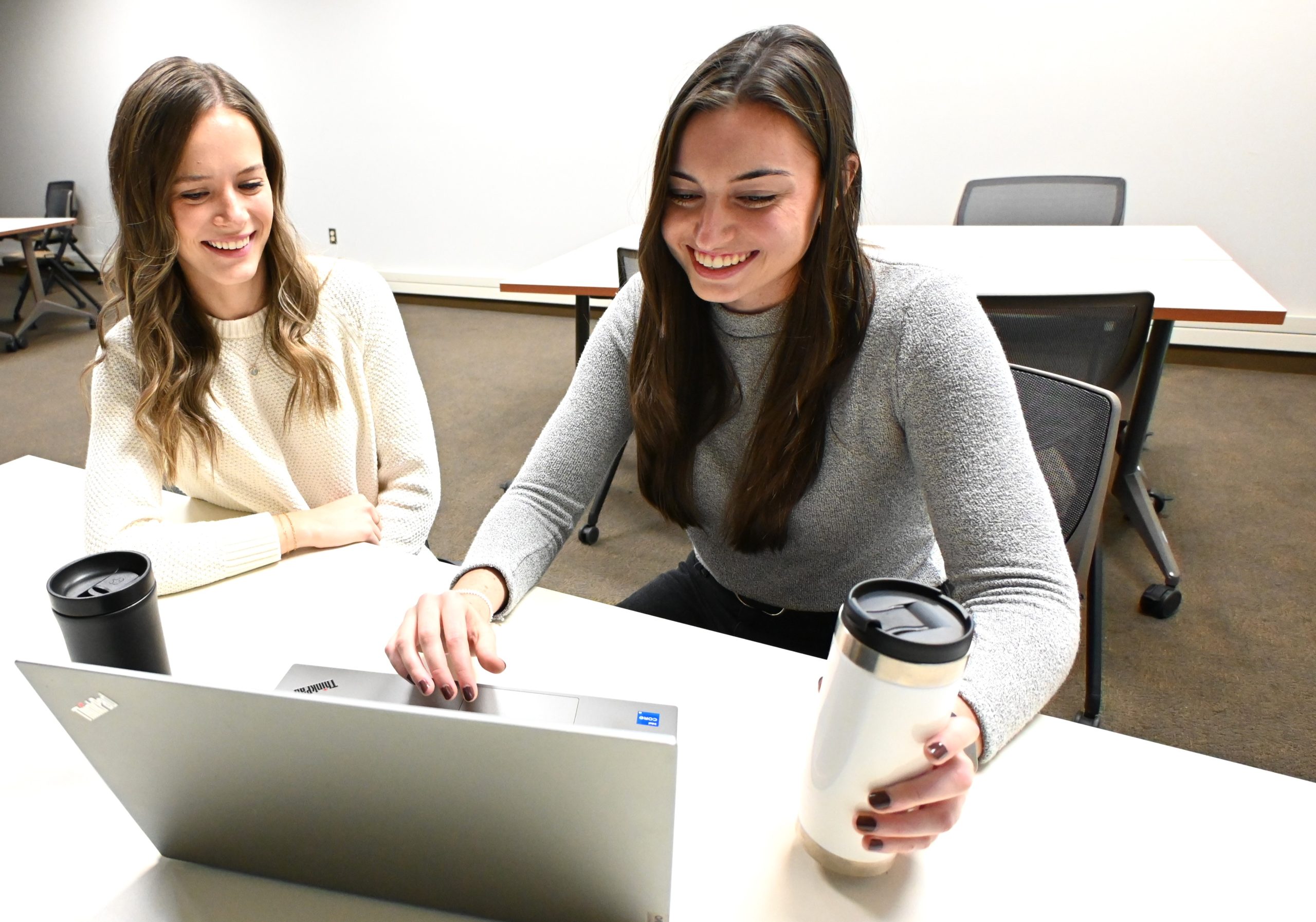 Photo of two women working together in a professional setting