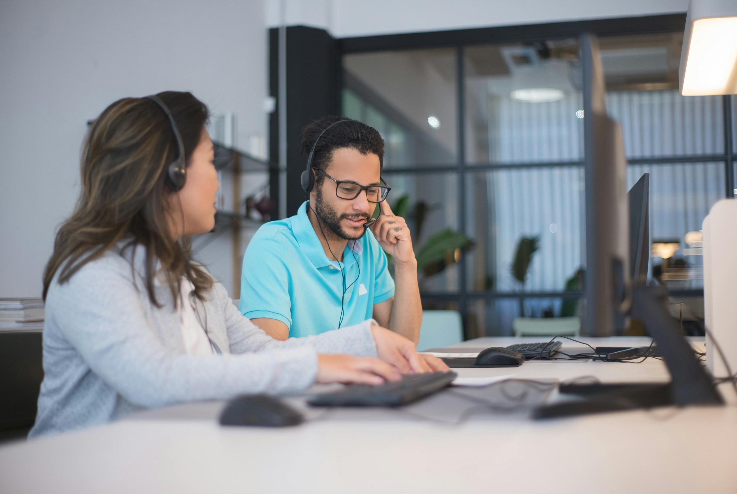 Photo of two women working together in an office setting